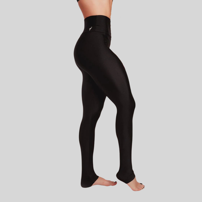 Black leggings worn by a person on a gray background